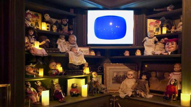 Creepy dolls on shelves inside Zak Bagans’ The Haunted Museum