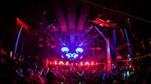 People inside Tao Nightclub with a DJ and lights