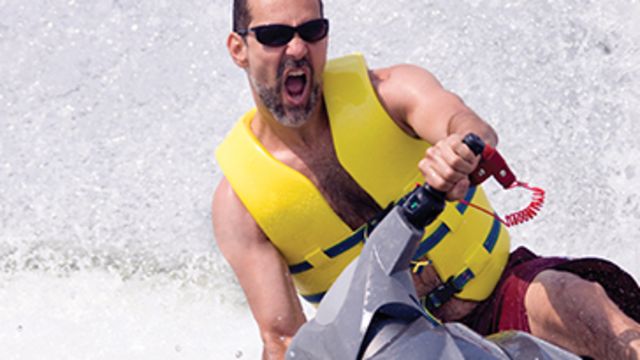 Man on a jet ski with a yellow life vest