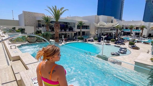 Woman looking out over the pool at Palms Casino Resort