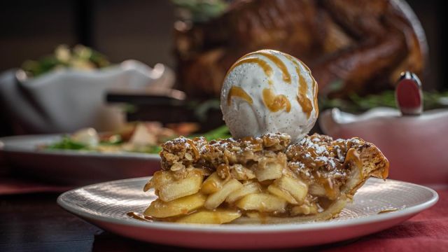 A delicious apple pie topped with ice cream for Thanksgiving dinner.