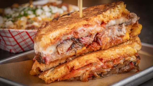 Take a bite of this delicious, ooey-gooey Briskted grilled Cheese sandwich at Mabel's Bar & Q inside of Palms Casino Resort only found in Las Vegas.