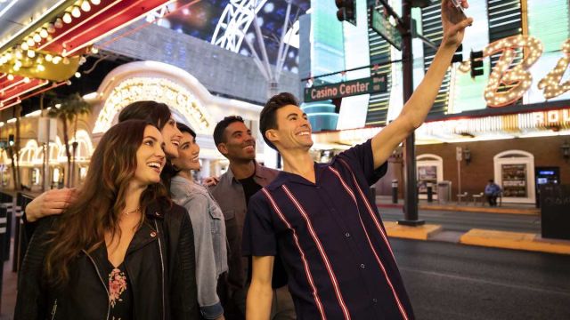 A group of friends taking a selfie together in Downtown Las Vegas. Shot by Scott Chebegia.