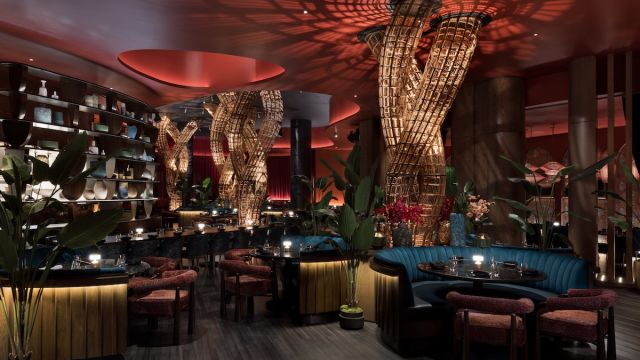 View of the interior dining area at Komodo Restaurant inside Fontainebleau Las Vegas, dimly lit and made up of earth tone colors. PHOTO CREDIT CONNIE ZHOU