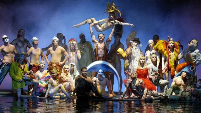 A group of performers posing on stage during the O show by Cirque du Soleil.