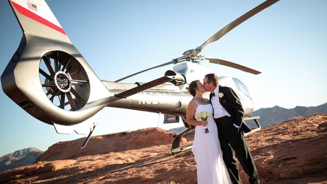 Married Couple Posing in Front of a Helicopter