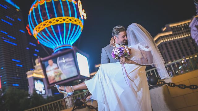 A joyful newlywed couple outside of Paris Las Vegas.