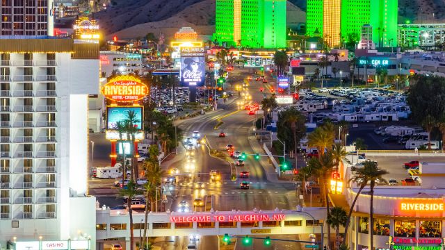 An aerial view of the Welcome to Laughlin sign illuminated at night.