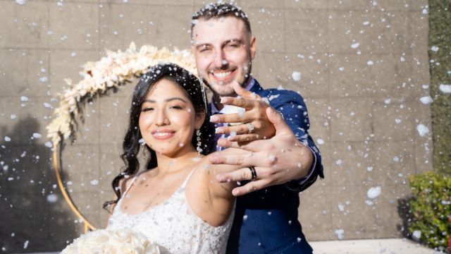 Couple showing off their wedding bands after marriage at Chapel of the Flowers
