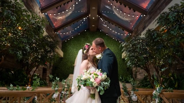 Couple kissing during wedding at the Glass Garden at Chapel of the Flowers