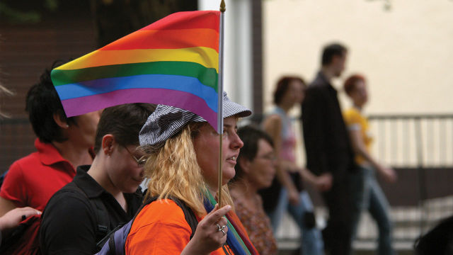 Woman holding a Pride flag