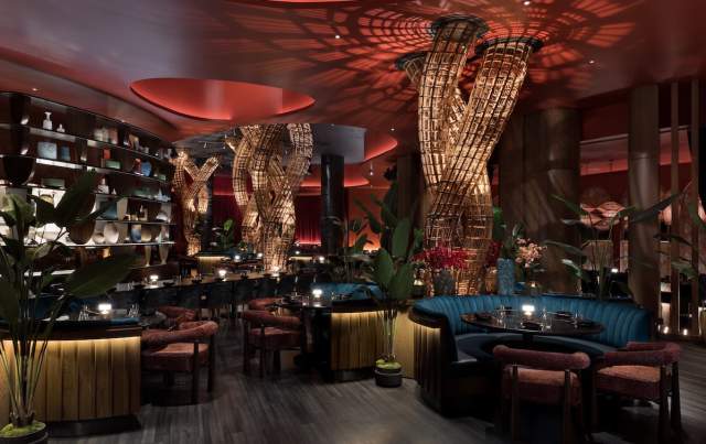 View of the interior dining area at Komodo Restaurant inside Fontainebleau Las Vegas, dimly lit and made up of earth tone colors. PHOTO CREDIT CONNIE ZHOU