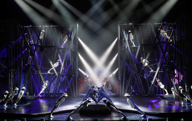 A group of performers doing the infamous Michael Jackson lean on stage during the Michael Jackson ONE show by Cirque du Soleil.
