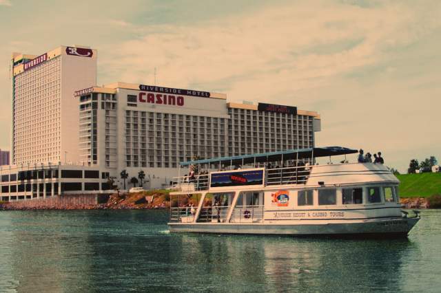 The USS Riverside floats past the Riverside Resort Hotel & Casino in Laughlin, NV