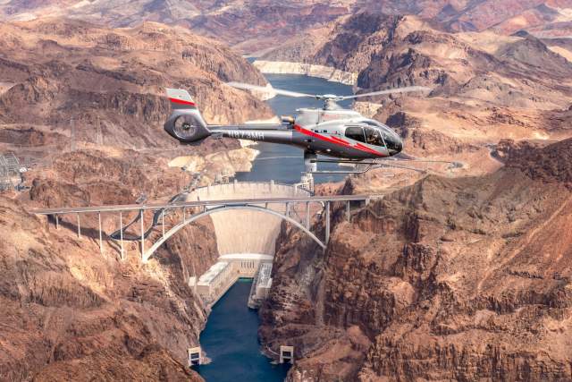 Maverick Helicopter flying over Hoover Dam