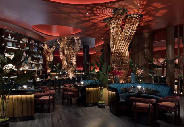 View of the interior dining area at Komodo Restaurant inside Fontainebleau Las Vegas, dimly lit and made up of earth tone colors. PHOTO CREDIT CONNIE ZHOU