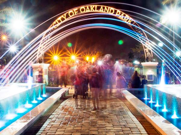 Visitors enjoy the bright lights and family-friendly atmosphere of Jaco Pastorius Park in Oakland Park Florida