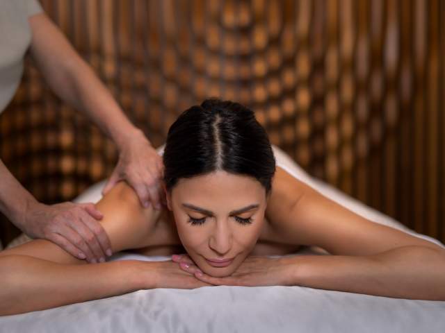 woman getting massage at the Palms Spa