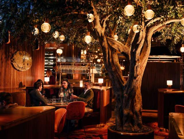 A group of people enjoying a wonder meal at Barry's Downtown Prime in Las Vegas.