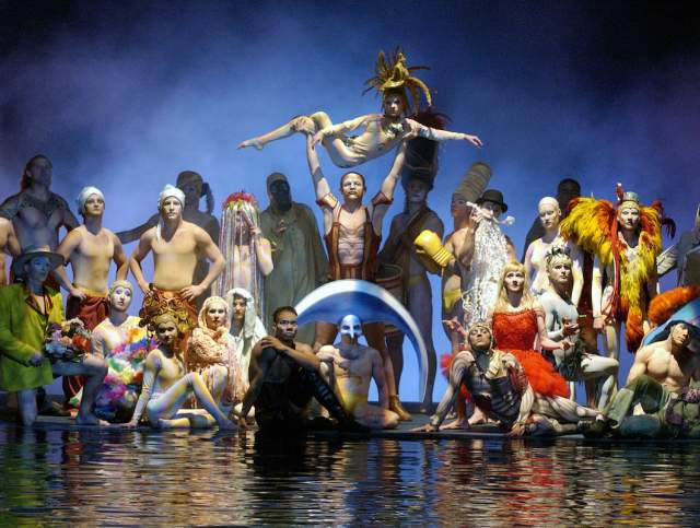 A group of performers posing on stage during the O show by Cirque du Soleil.