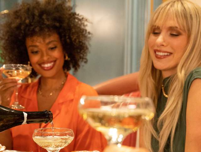 Two friends drinking some delicious wine at Sadelle's Cafe at Bellagio.