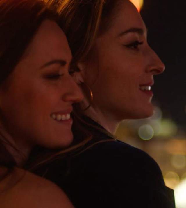 a female couple embracing in Las Vegas at night