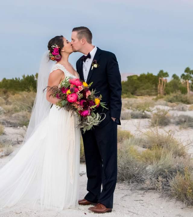 Bride and Groom kissing in the desert landscape
