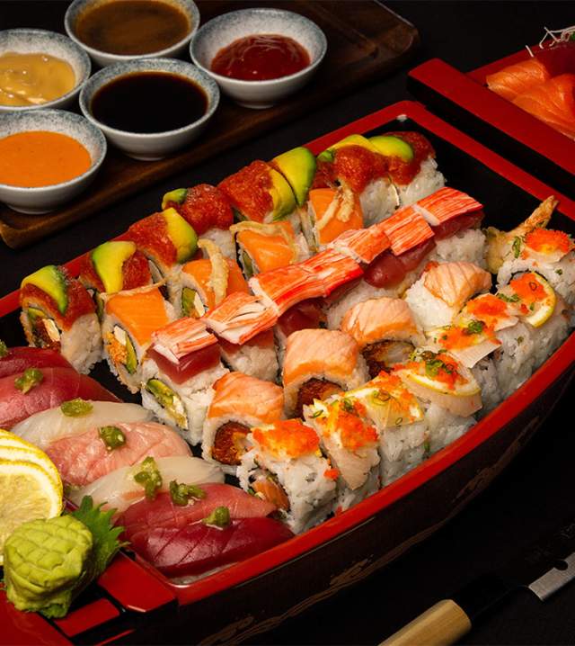 Variety of sushi plated in a boat