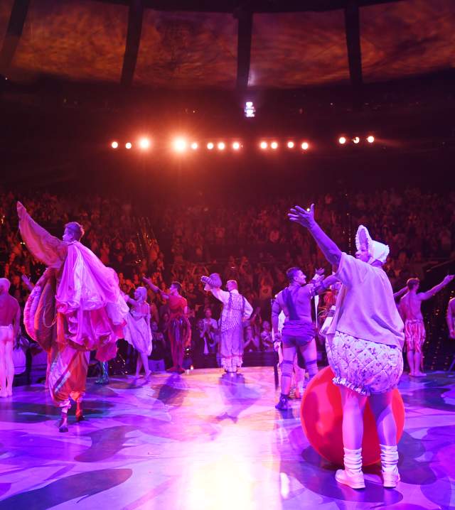 A group performers singing on stage during the Mystere show by Cirque du Soleil.
