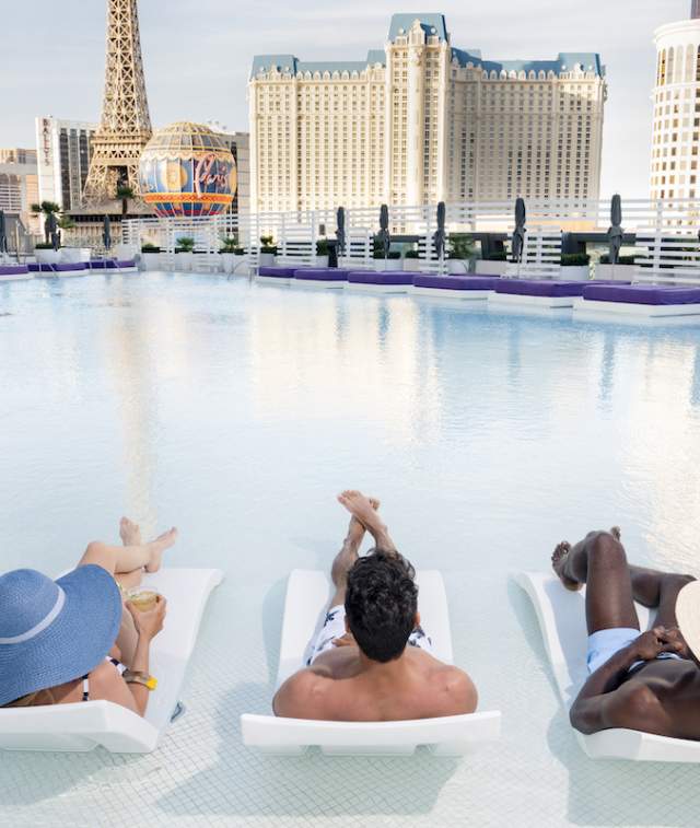 A group of people soaking up the sun in the fabulous pool at the Cosmopolitan in Las Vegas.