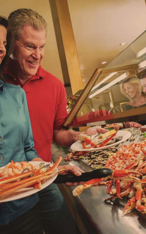 Photo of couple dishing up crab at buffet in Laughlin, Nevada