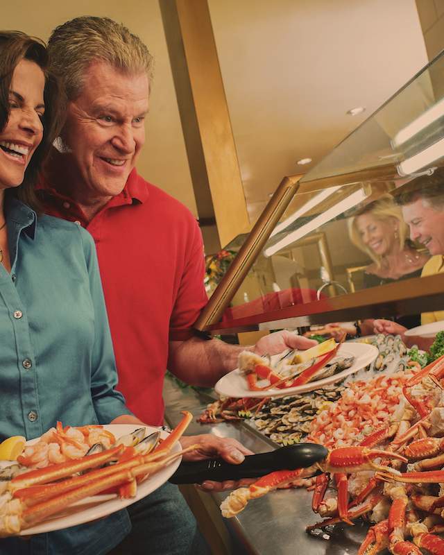 Photo of couple dishing up crab at buffet in Laughlin, Nevada