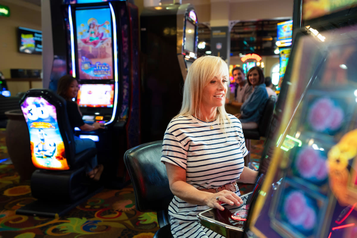 A woman having a great time playing slots at Tropicana Laughlin Hotel and Casino in Laughlin, Nevada!