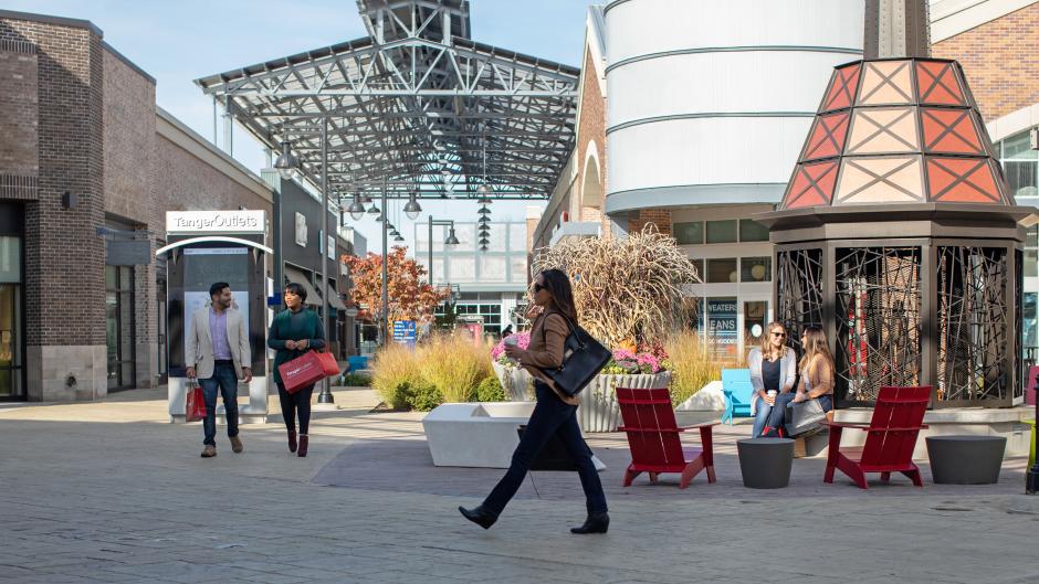 A group shopping and sitting at Tanger Outlets Grand Rapids, 2018.