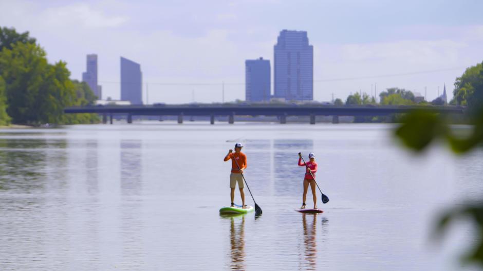 Stand up paddling towards downtown on the Grand River.