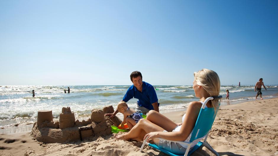 Happy Family Building a Sandcastle on a Beach near Grand Rapids
