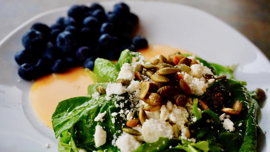 Don't miss out on Rush Creek's Blueberry-Peach Salad with baby spinach, arugula, blueberries, toasted pepitas, feta crumble, and roasted peach vinaigrette