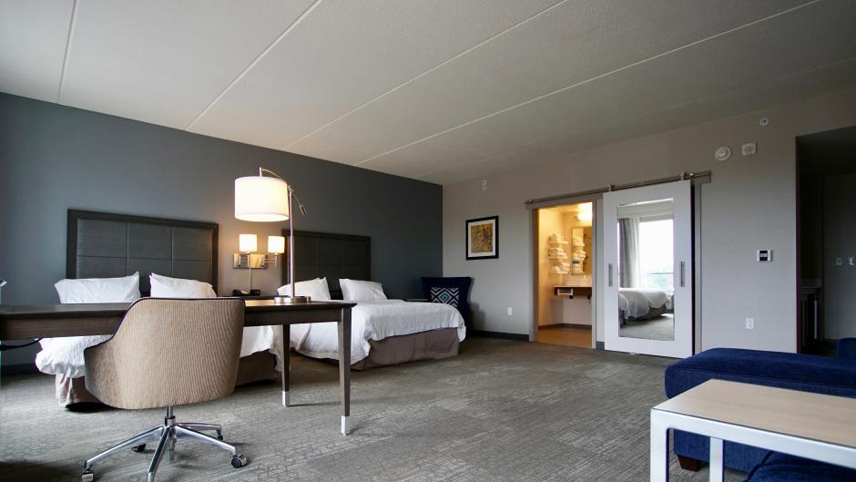 Accessible hotel room with two beds and large, open space at the Hampton Inn.