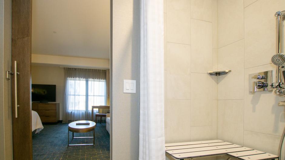 Accessible bathroom and hotel room at Embassy Suites hotel.
