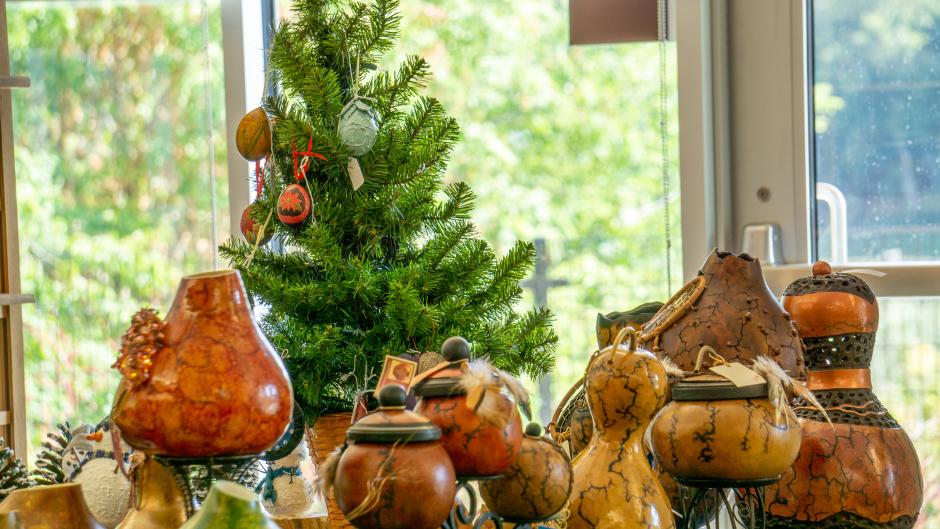 Painted and decorated gourds on a table at the Frederik Meijer Gardens gourd painting class.