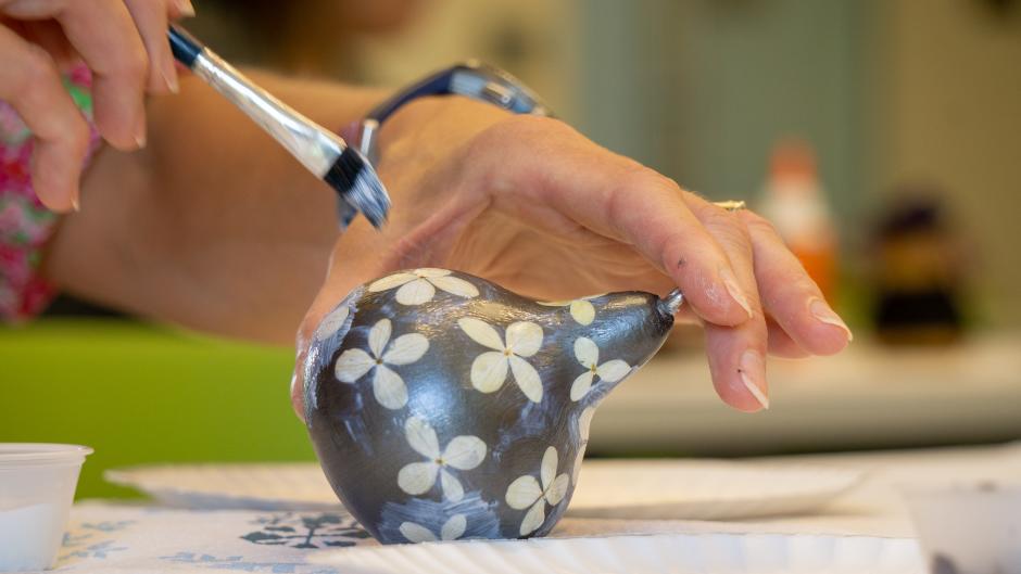 Silver-painted gourd with white flowers at Frederik Meijer Gardens' art class.