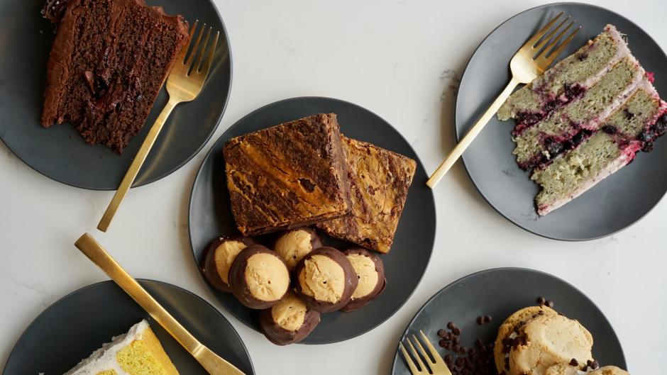 Five plates with assorted vegan desserts