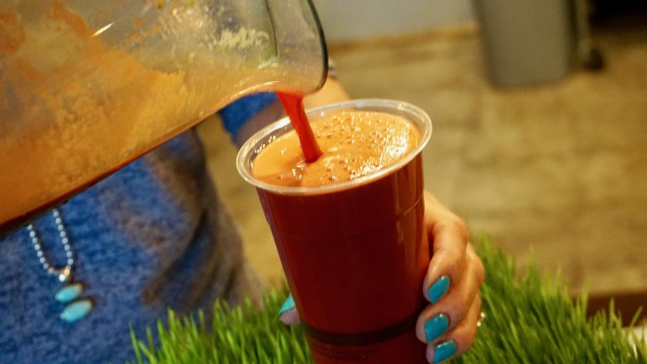 Pouring a smoothie at Sip Juice Bar