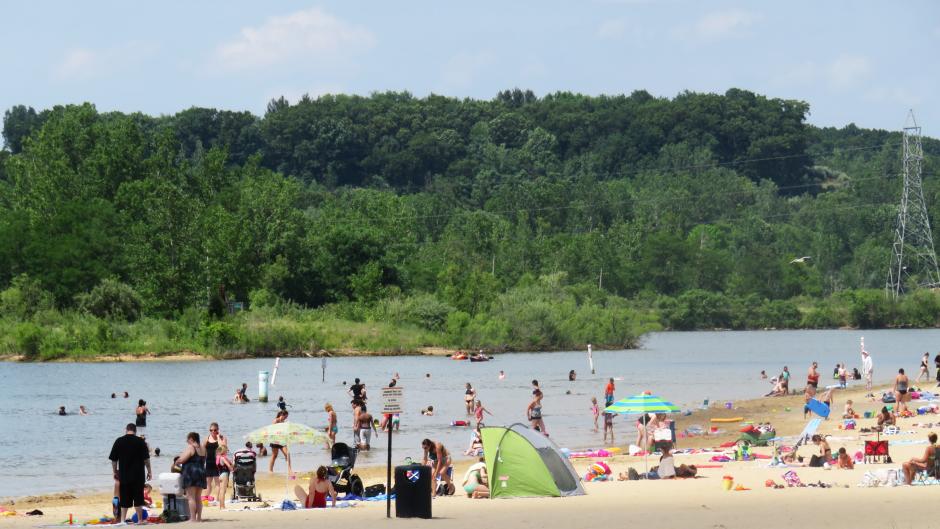 Beach goers enjoy the sunshine and waves at Millennium Park.