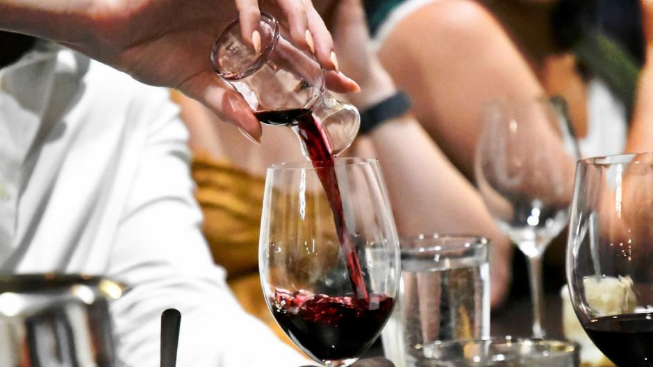 Pouring red wine during Raise a Glass Wine Tour