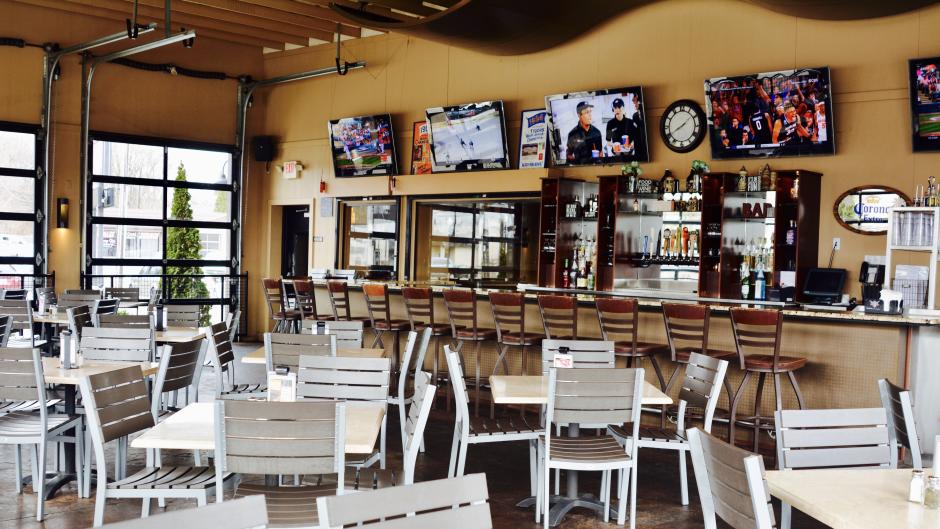 With glass garage doors for walls, this newly added 3-season patio is a fantastic place to enjoy great food and watch your favorite game.