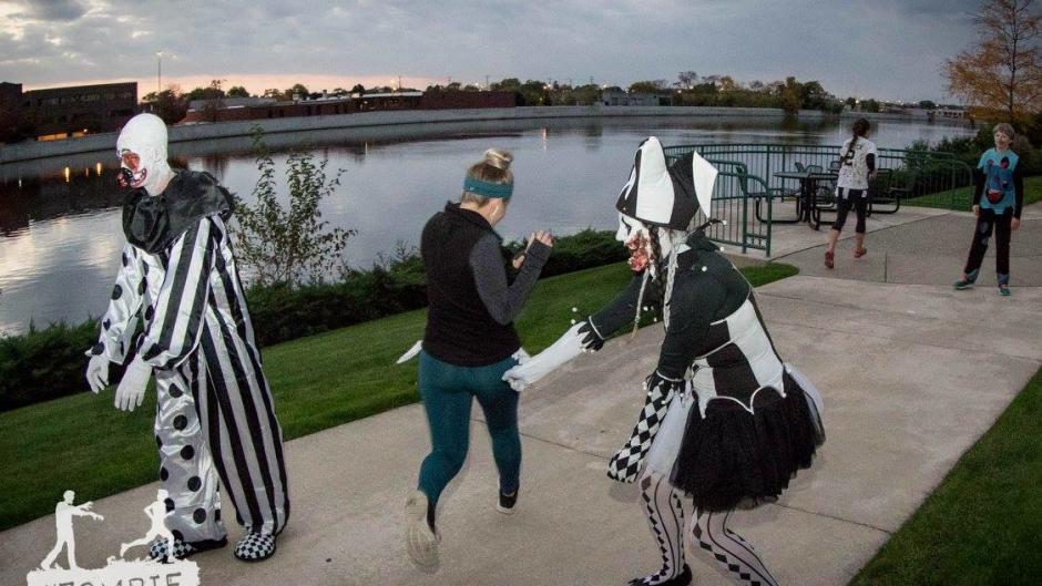 A runner tries to avoid the two zombie clowns during the Zombie Dash.