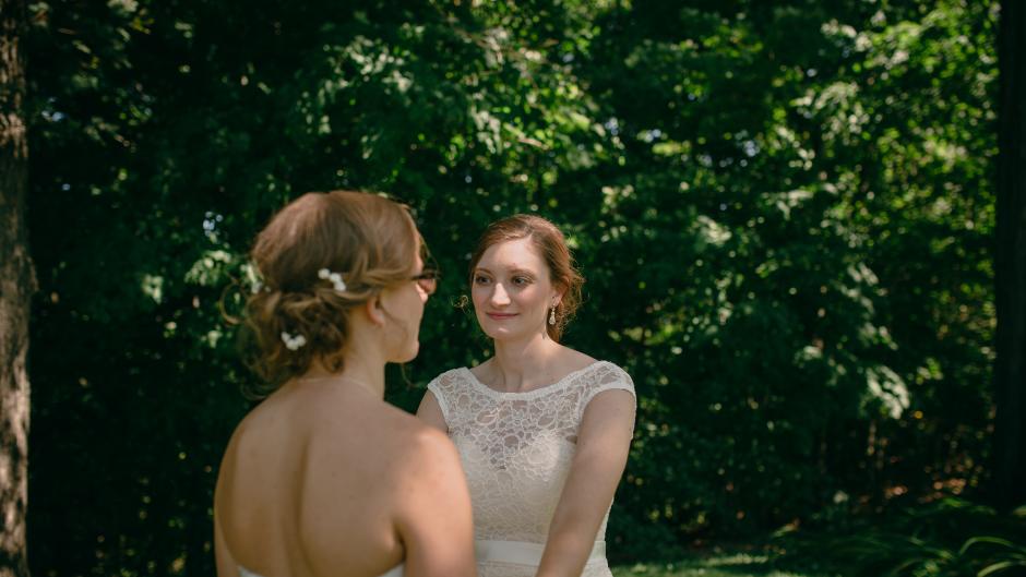 Brides holding hands in Fallasburg Park