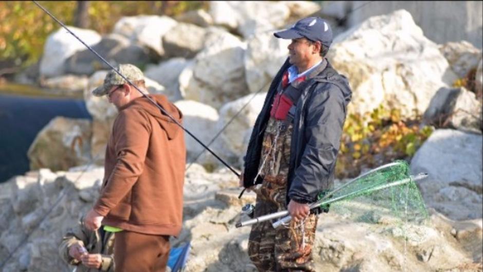 Anglers often gather along the river bank at the Sixth St. Dam where they swap stories and watch each other fish