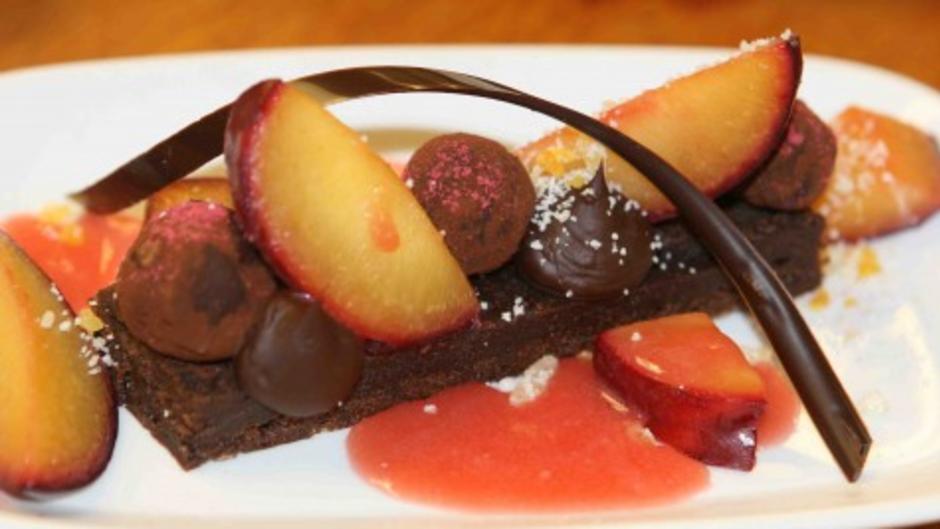 Amway Grand Plaza's Flourless chocolate cake with fresh plums and plum and champagne sauce.